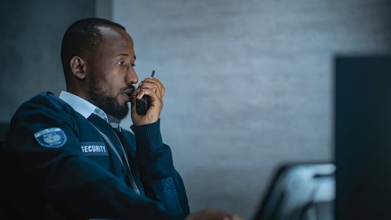 Security officer in monitoring center working night shift